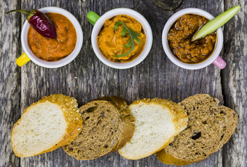 various pesto on the wooden table flat lay