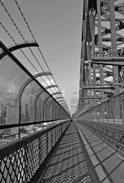 Fototapeta view along the walking path on Sydney harbor bridge in black and white, Australia 