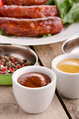 Sausage. Delicious sausages in a plate with ingredients. Salad.