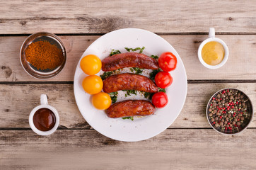 Sausage. Delicious sausages in a plate with ingredients. Salad.