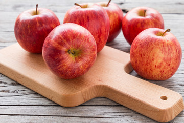Red apple on rustic wooden table background