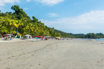 Fototapeta premium Parasol with chairs at Playa Espadilla at Manuel Antonio Park - Costa Rica