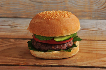 one hamburger on wooden background