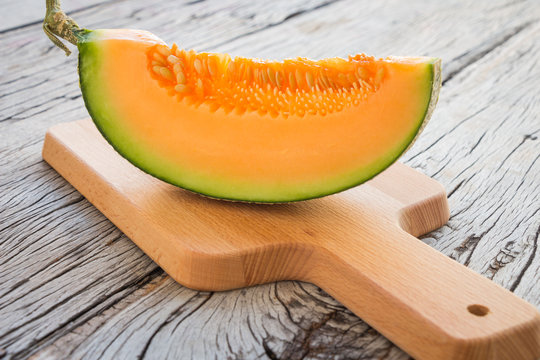 Fresh melons sliced on wooden table