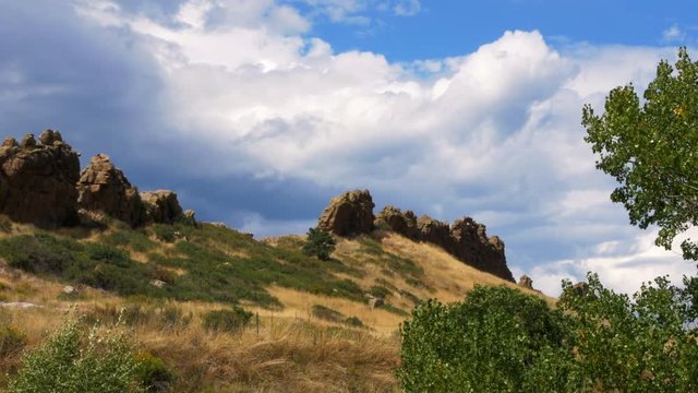 Time lapse footage of cumulus clouds in a beautiful blue sky over Devils Backbone near Loveland Colorado.