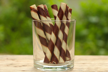 Chocolate wafer sticks with green background.
