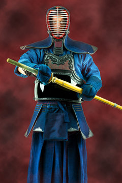 Kendo - Kendoka in full armor and bamboo sword. Studio shot.