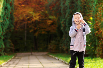 Little boy looks charming while adjusting his headphones