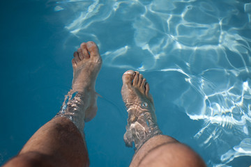 Bare feet in the water - obrazy, fototapety, plakaty