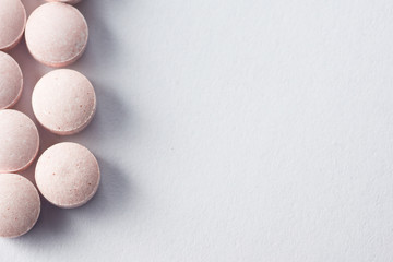 Multiple pills depicting medical treatment or pahrmaceutical ind