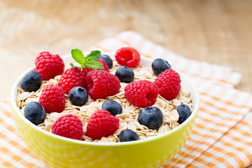 Oatmeal porridge with berries. Raspberries and blueberries.