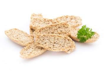 Dry flat bread crisps with herbs on a white background.