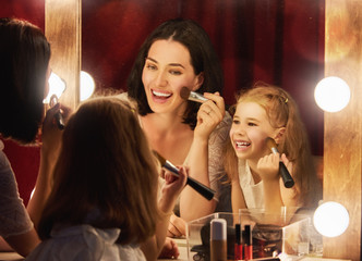 Mother and daughter are doing makeup