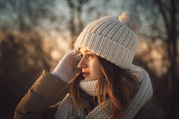 Blurred picture of lady wearing in white winter hat and scarf, s