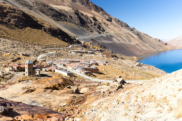 Mountain village town stone buildings old abandoned houses, lake, Bolivia. 