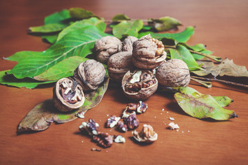 Fototapeta na wymiar Several walnut kernels and lie on brown background