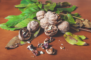 Several walnut kernels and lie on  brown background
