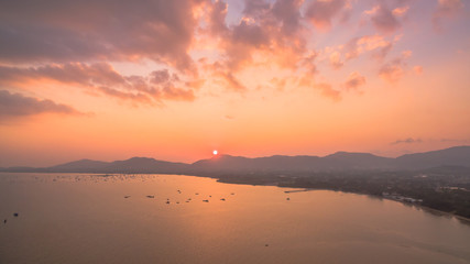 the sun above big Buddha 
 big Buddha on the mountain can see from Panwa cape. aerial photography from Panwa cape you can see Palay pier, Chalong pier and boats in Chalong bay