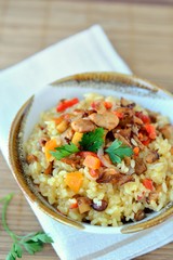Risotto made of rice with mushrooms(chanterelle), peppers and pumpkin