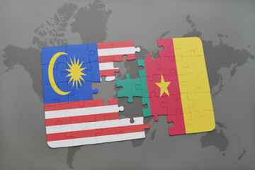 puzzle with the national flag of malaysia and cameroon on a world map background.