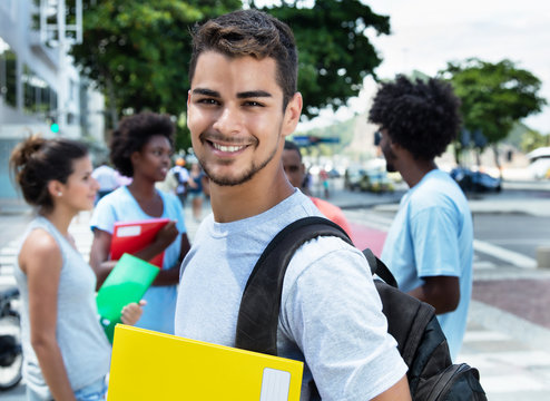 Laughing Latin Male Student With Group Of Friends