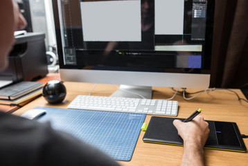 Young man at home using a computer, freelance developer or designer working