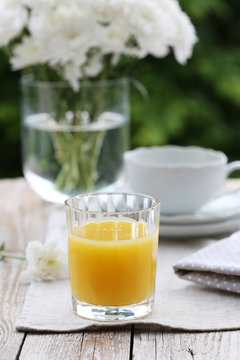 Summer breakfast in garden: orange juice