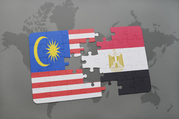 puzzle with the national flag of malaysia and egypt on a world map background.