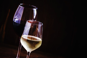 White and red dry wine, vintage wooden dark background, space fo