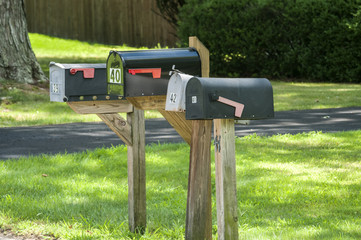American outdoor metal mailboxes on wooden supports