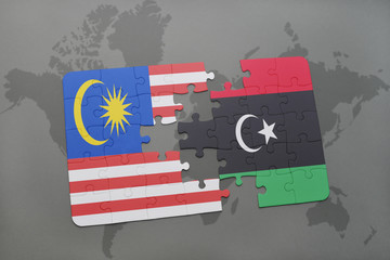 puzzle with the national flag of malaysia and libya on a world map background.