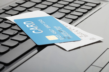 A credit card and a receipt over computer keyboard as a symbol of online shopping