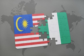 puzzle with the national flag of malaysia and nigeria on a world map background.