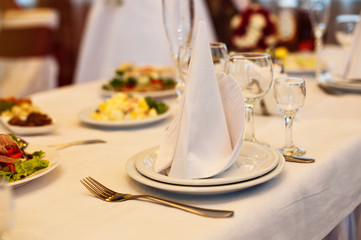 served a festive table for wedding dinner in the restaurant