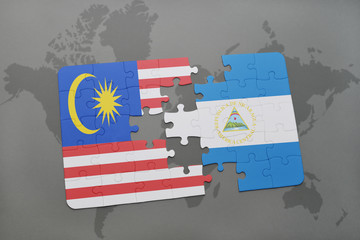 puzzle with the national flag of malaysia and nicaragua on a world map background.