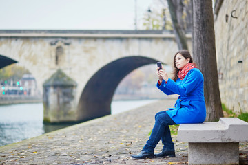 Beautiful young tourist in Paris on a fall or spring day