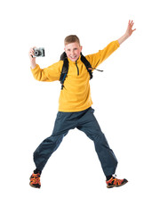 Young red-haired boy in a yellow jacket and a backpack holding an old camera and smiling on a white background