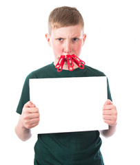 Young and frustrated boy with clothespins on his lips holds in hands an empty plate on a white background