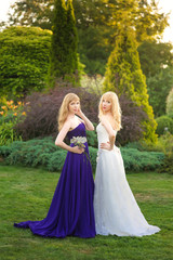 Fototapeta premium Bride and bridesmaid outside