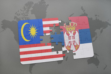 puzzle with the national flag of malaysia and serbia on a world map background.