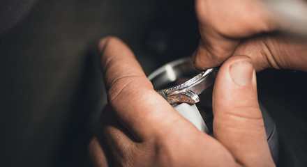 Engraving details onto his latest ring