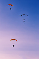 Silhouette of parachute on sunset background