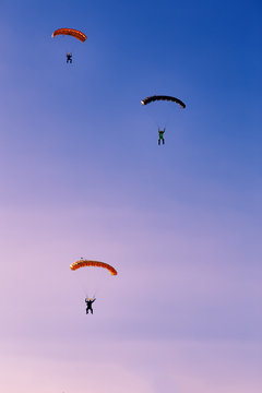 Silhouette of parachute on sunset background