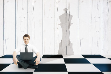 Businessman with chess king shadow