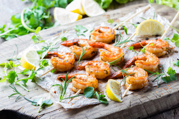 Grilled fried Shrimps Prawns on wooden skewers with spices