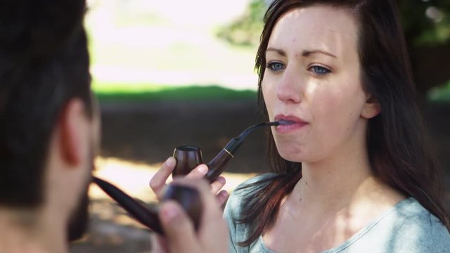 Closeup of woman smoking pipe