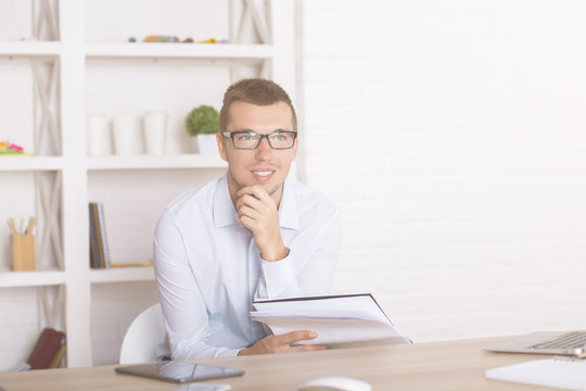 Man with paperwork thinking