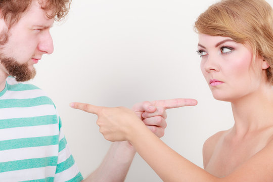 couple pointing fingers at each other, conflict
