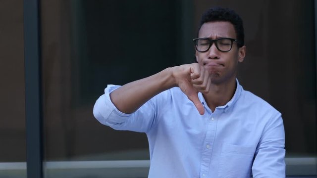 Gesture of Unsatisfaction, Thumbs Down by Young Black Handsome Man