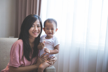 happy mother holding her baby